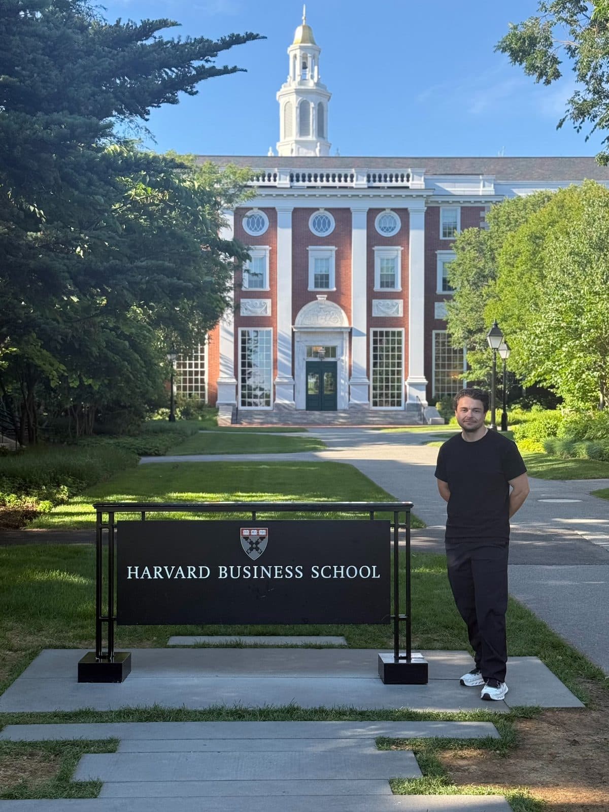 Florian Raschle in front of the Harvard Business School sign in Boston